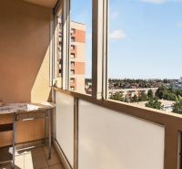 A balcony in a one-room apartment on Jiráskova Street in Trnava with a view of the city.