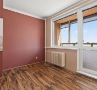 A room in a one-room apartment with a window and a floor with a wooden decor.