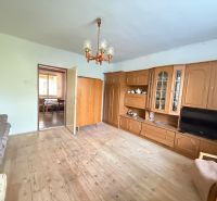Living room in a family house with a wooden decor floor and a living room wall unit.