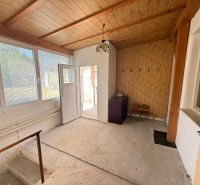 Interior of a family house with wooden paneling and entrance door.