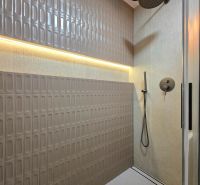 Shower corner with ceramic tiles and a rain shower in a 3-room apartment.