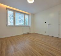 A bright room with a wooden decor floor in a 3-room apartment.