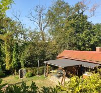 A cottage with a garden and trees in the Gardens on 1st May Street in Košice - Krásna district.