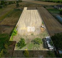 Residential plots in Tomášov, Podzáhradná Street, visible agricultural crops.