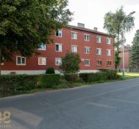 Red brick building surrounded by greenery on 9th May Street in the town of Svit.