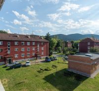 Brick buildings with parking and greenery in Svit on 9. mája Street, ideal for a 1-room apartment.
