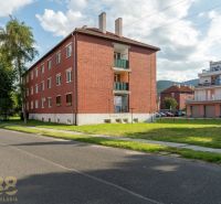 Apartment building on 9th May Street in the town of Svit, next to a green lawn.