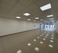 Commercial spaces with large windows and tiled floors.