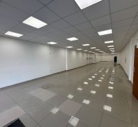 Commercial spaces with light floors and white walls, available for rent.