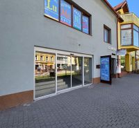 Commercial premises on St. Egidius Square, Poprad, with a glass facade and paving in front of the entrance.