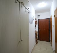 Entrance hallway in a 2-room apartment with tiled flooring and wardrobes.