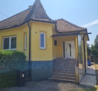 A family house in Komjatice with a sloped roof and yellow facade.