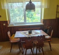 Dining area in a family house with wooden paneling and a classic table.