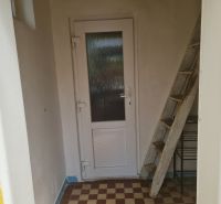 Entrance to a family house in Komjatice with stairs and doors.