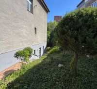A family house on Krátka Street, Bratislava - Staré Mesto, surrounded by greenery, with a blue sky.