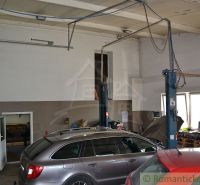A garage in a family house with cars and a car lift, floor with wooden decor.
