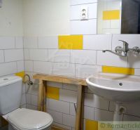 A bathroom in a family house with tiles in white and yellow color.
