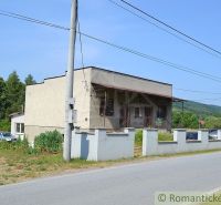 A family house in Varadka with fencing by the road and surroundings with forests.