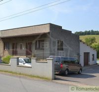 A family house in Varadka with a concrete fence and landscaped surroundings.