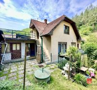 A family house in Žiar nad Hronom with two floors, surrounded by greenery and forest.