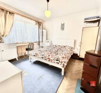 Bedroom in a family house with a bed, carpet, and desk.