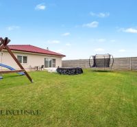 A family house in Vozokany with a trampoline and a gazebo on the lawn.