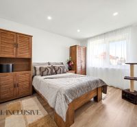 A bedroom in a family house with wooden decor and plenty of natural light.