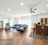 Living room in a family house with comfortable seating and a wooden decor floor.