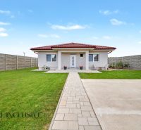 A family house in Vozokany with a lawn, terrace, and a bicycle in front of the entrance.