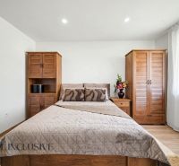 A bedroom in a family house with wooden furniture and a floor with a wooden decor.