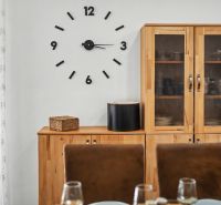 Dining room in a family house with a clock on the wall and wooden furniture.
