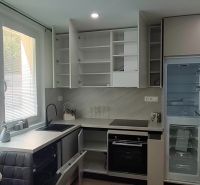 A kitchen in a 3-room apartment with a marble countertop and built-in appliances.