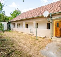 A family house in Kapince with a terrace, wooden doors, and a satellite dish on the roof.