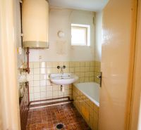Bathroom in a family house with a boiler and a shower tray.