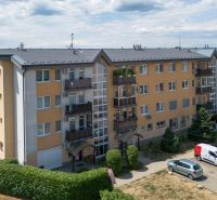 Apartment building on M.R. Štefánik Street in Most pri Bratislave, parking lot, greenery.