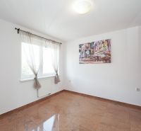 A bright room with a large window, built-in wardrobe, and tiles in a 3-room apartment.