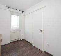 A bright room in a 3-room apartment with a wooden decor floor.