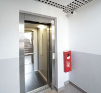 Elevator, staircase, red fire extinguisher in the interior, entrance to a 3-room apartment.