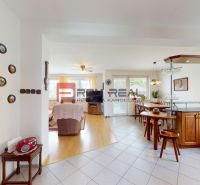 Open living spaces with a kitchen and dining area, wooden decor flooring.