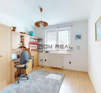 Children's room with a desk and cabinets, wooden decor flooring, family house.