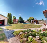 A family house in Senec with a garage, landscaped garden, and swimming pool.