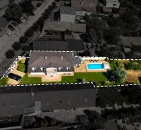 Aerial view of a family house in Senec with a garden and a swimming pool.