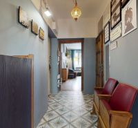 A hallway with decorative lighting, tiled floor, and decorations in a 2-room apartment.