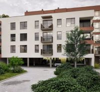 An apartment building on Brigádnická Street in Piešťany with greenery and parking.