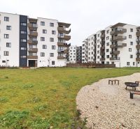 Residential complex on Višňová Street in Bytča with greenery and a children's playground.
