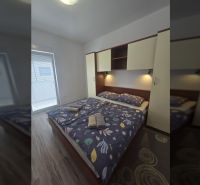 Bedroom with a double bed in a 2-room apartment, floor with wood decor.