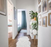 A beautiful hallway in a 2-room apartment with a wooden decor floor and decorations.