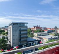 View from the balcony of a 2-room apartment to the panorama of Trnava with historic buildings.