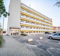 Apartment building on 1. mája in Pezinok with parking in front of 2-bedroom apartments.
