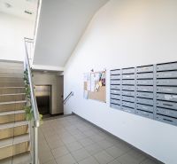 Entrance to the building on 1. mája in Pezinok with mailboxes and staircase.